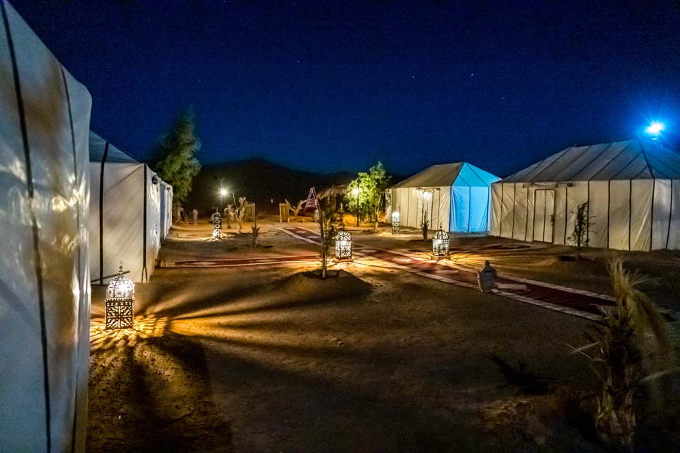 The Real Charm of the luxury Berber Camp under the dazzling array of stars in the clear Sahara Desert Night Sky in Merzouga Erg Chebbi Dunes.